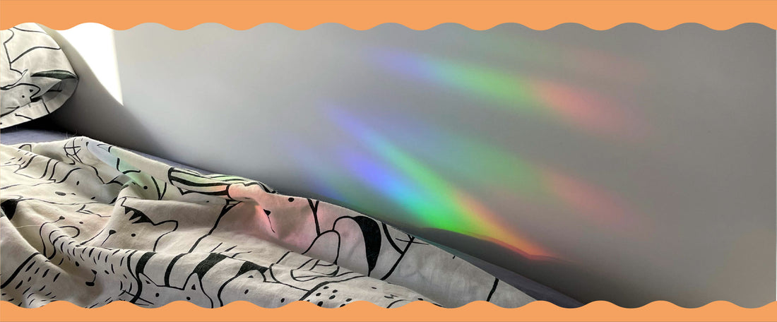 Gifts She'll Love - Rainbow light rays over a white bed sheet. Sun Catchers make a great teacher gift for under $15
