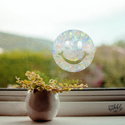 Smiley Face Window Sticker. Rainbow light reflections across the room. Looks great next to plants and crystals. Perfect home decor and makes the best gift for children and adults on their birthday or on Christmas.