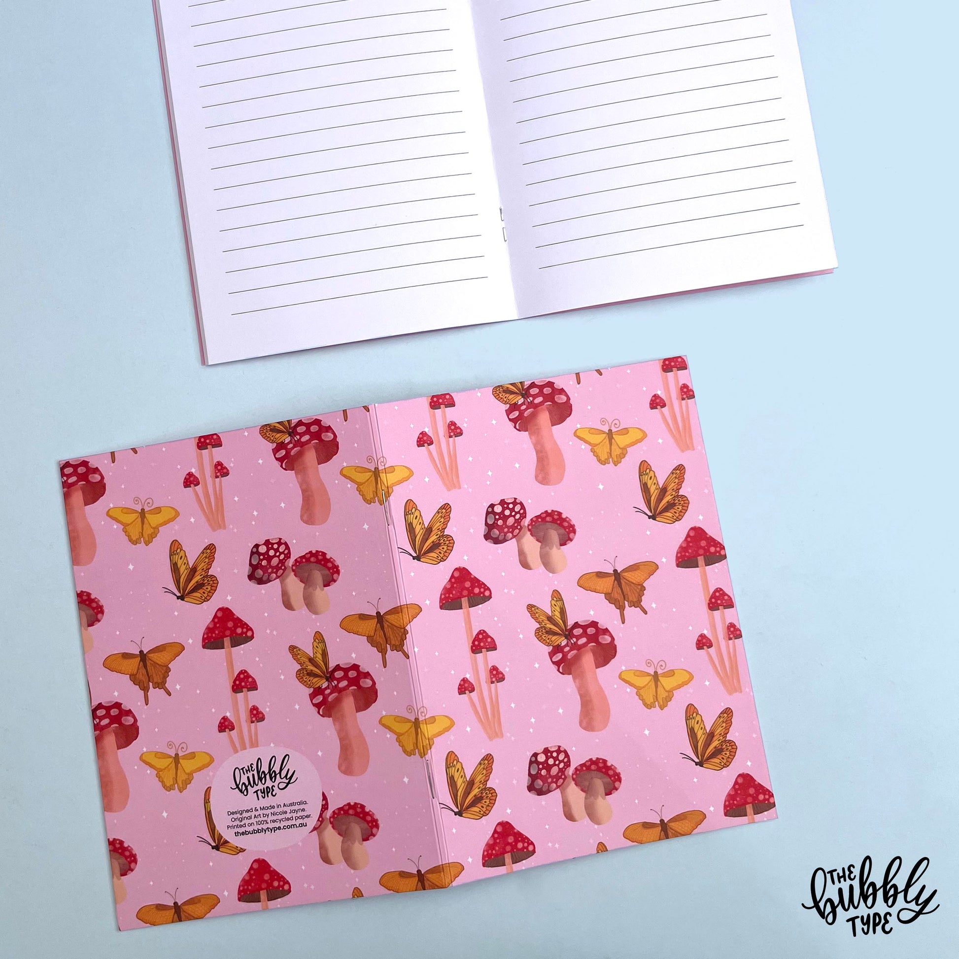 Handmade A5 notebook with mushroom and butterflies pattern cover, featuring original artwork by Nicole Jayne for The Bubbly Type, 32 lined pages on 120gsm premium uncoated paper, eco-friendly recycled matte finish, ideal for notes, journaling, and gifts.