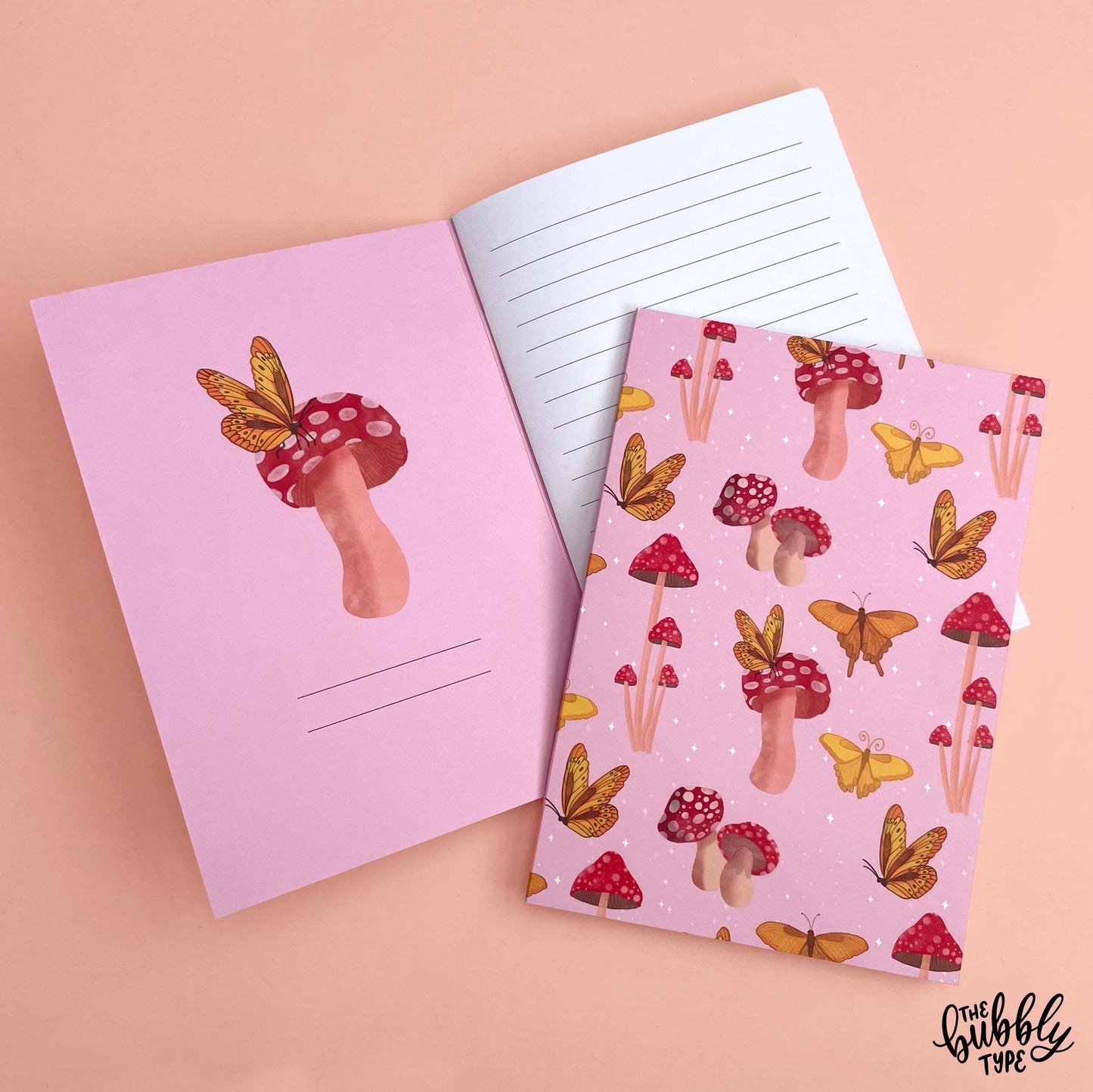 Handmade A5 notebook with mushroom and butterflies pattern cover, featuring original artwork by Nicole Jayne for The Bubbly Type, 32 lined pages on 120gsm premium uncoated paper, eco-friendly recycled matte finish, ideal for notes, journaling, and gifts.