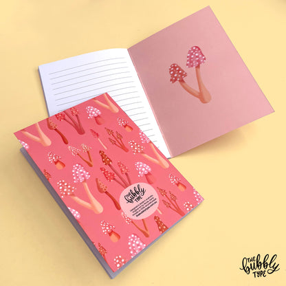 Handmade A5 notebook with mushrooms pattern cover, featuring original artwork by Nicole Jayne for The Bubbly Type, 32 lined pages on 120gsm premium uncoated paper, eco-friendly recycled matte finish, ideal for notes, journaling, and gifts.