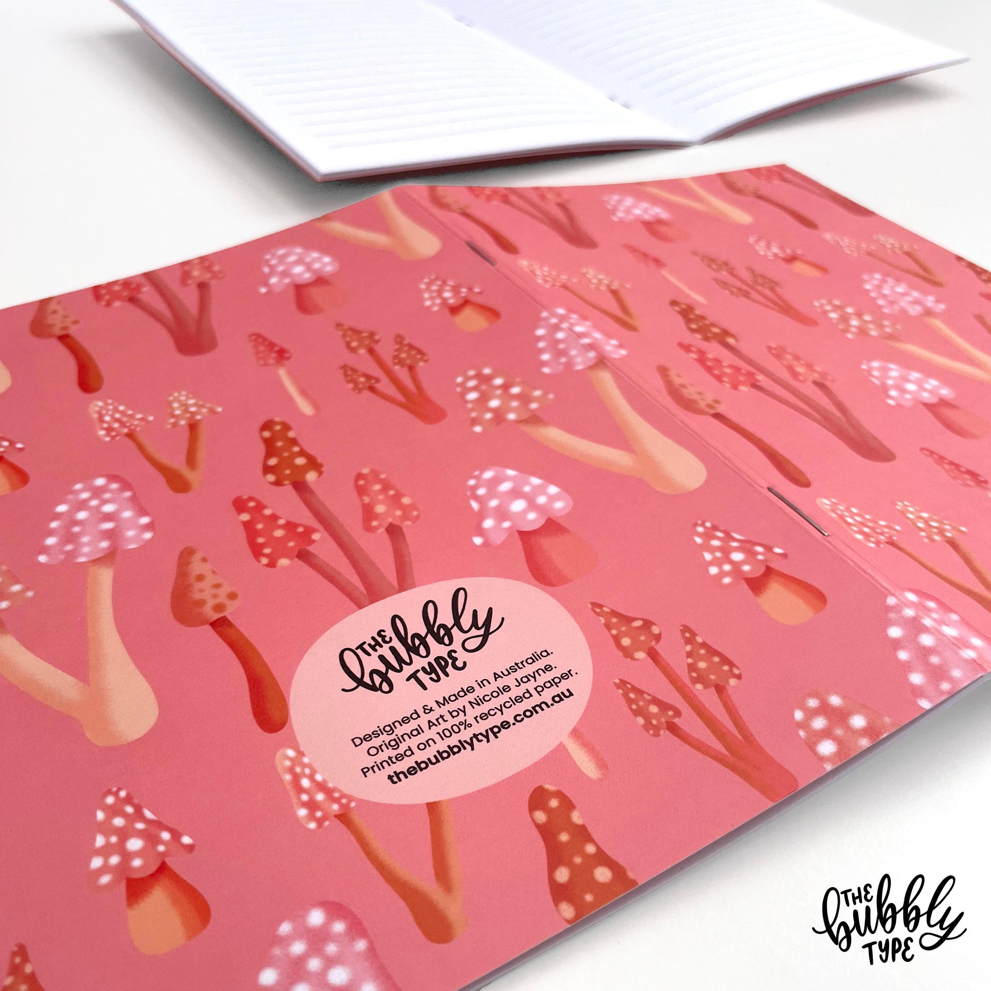 Handmade A5 notebook with mushrooms pattern cover, featuring original artwork by Nicole Jayne for The Bubbly Type, 32 lined pages on 120gsm premium uncoated paper, eco-friendly recycled matte finish, ideal for notes, journaling, and gifts.